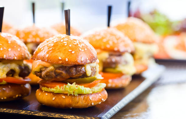 istock Burgers on wooden table in restaurant . 687483906