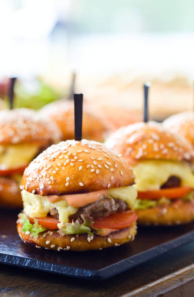 istock Burgers on wooden table in restaurant . 687483922