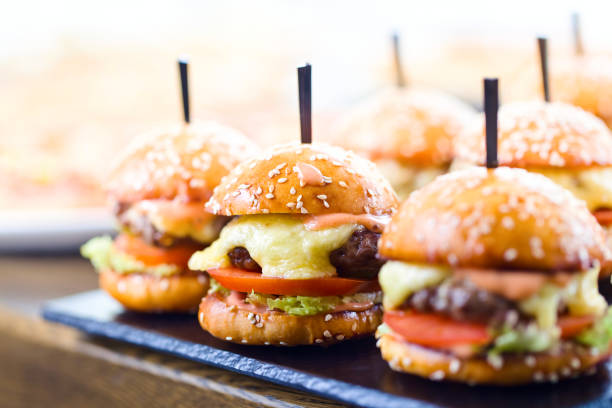 istock Burgers on wooden table in restaurant . 687483930
