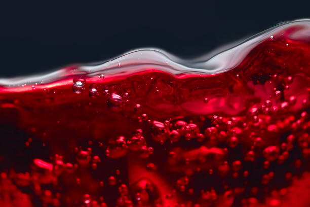 istock Abstract splashes of red wine on a black background 687483942