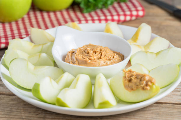 istock Green apple  sliced with peanut butter. 687484104