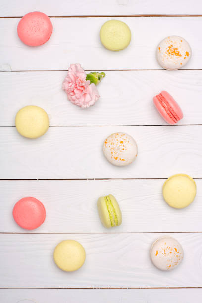 istock fresh macaroons in waffle cones on wooden surface 687484204