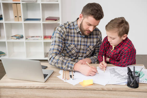 istock Businessman drawing with son at office 687487154