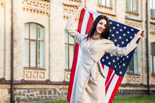 istock Beautiful happy woman with American flag celebrating independence day. 687487708