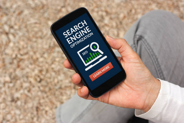 istock Hand holding smart phone with SEO concept on screen 687498138