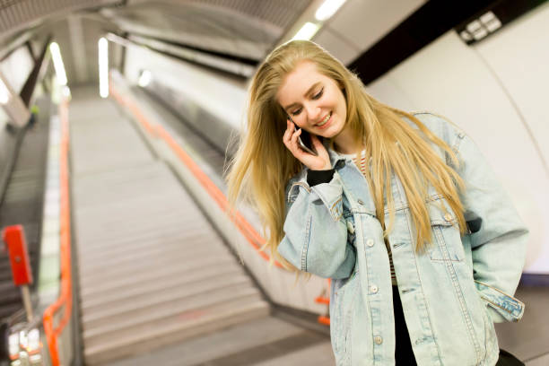 istock Young woman standing on a subway station 687498840