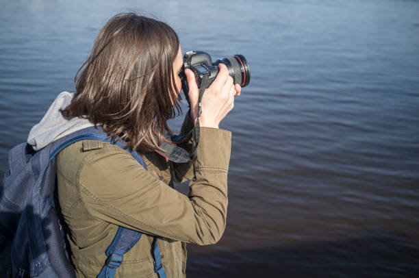 istock Cute woman photographer with camera in hands. 687498972