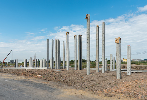 consruction site with  precast concret pile and pile-driver, prefabrication house structure design