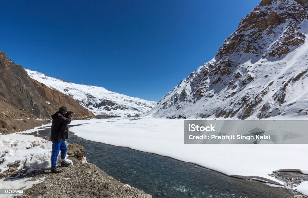 fully frozen pin valley photographer at  frozen pin valley in winter, spiti, himachal pradesh, india Adventure Stock Photo