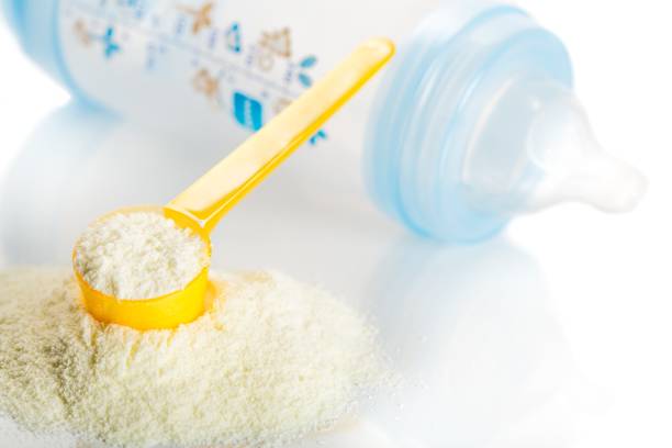 Powdered milk. Preparation of mixture baby feeding close up formula stock pictures, royalty-free photos & images