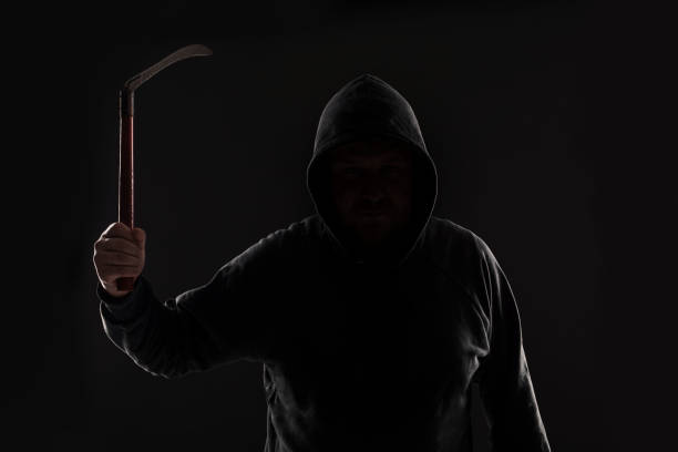 istock Criminal in dark clothes and balaclava with scythe 687512606