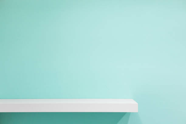 istock Empty white shop shelf, retail shelf on green vintage background. 687514916