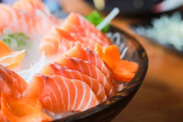 istock Salmon raw sashimi on brown Japanese traditional dish 687516368