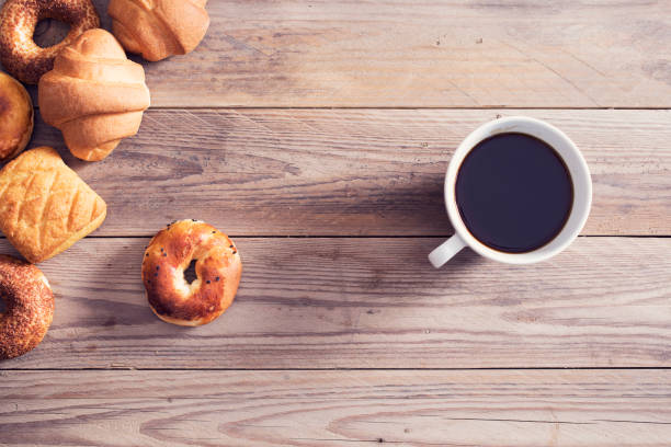 istock Pastry with coffee on wooden table 687517202