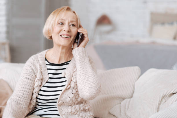 istock Enthusiastic positive senior lady calling someone 687519606