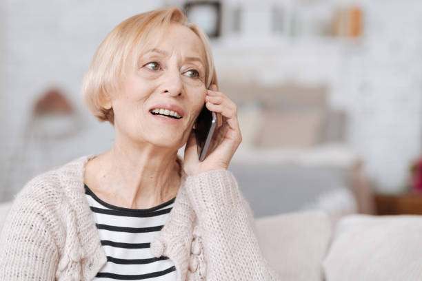 istock Cheery elderly woman calling her friend 687519696