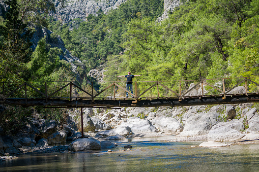 The Turkish man is walking on the bridge göğnük canyon in Antalya, Kemer.