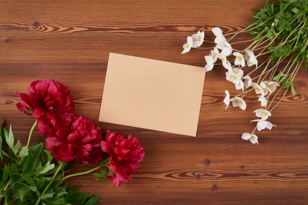 istock Top view envelope and spring flowers on wooden background 687523756