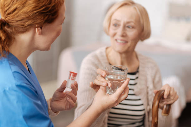 istock Kind trained nurse serving a glass of water 687523840
