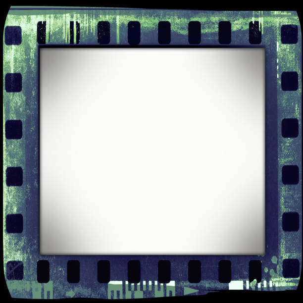 istock Vintage green film strip frame on old and damaged paper background. 687523912