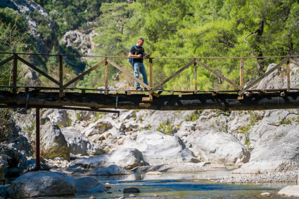 The Turkish man is walking on the bridge göğnük canyon in Antalya, Kemer.