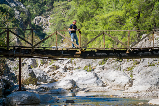 The Turkish man is walking on the bridge göğnük canyon in Antalya, Kemer.