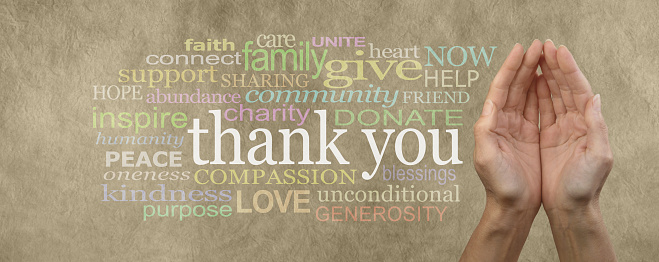 Female cupped hands on parchment effect background with a word cloud surrounding the word Thank You for seeking charitable donations and help