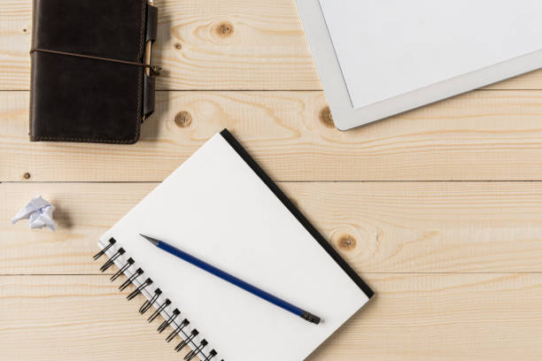 istock Top view of notebook with pencil and digital tablet at workplace, home office concept 687533766