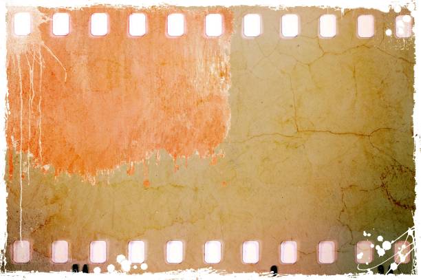 istock Vintage sepia film strip frame on old and damaged paper background. 687536150