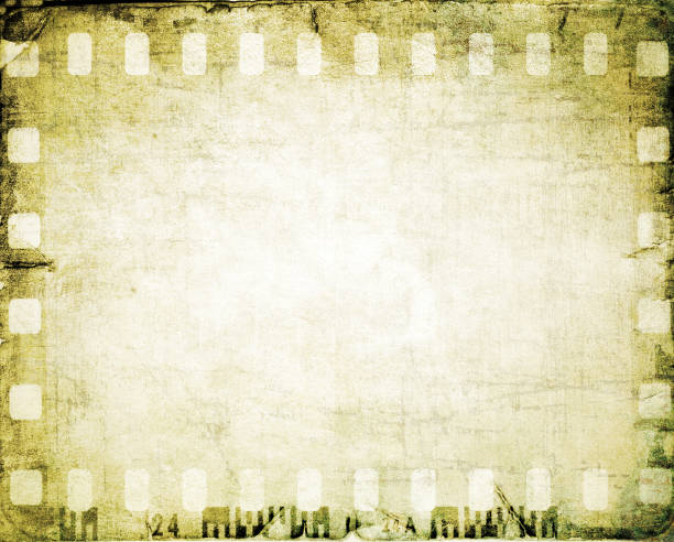 istock Vintage film strip frame on old and damaged paper background. 687540636