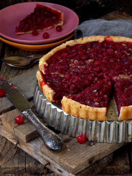istock Tart, cake with red cranberries and walnuts on wooden background. Berry pie. Space for text 687541696