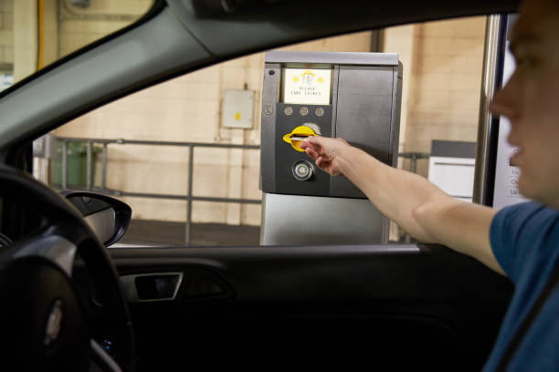 istock Driver Collects Ticket From Machine In Car Park 687549080