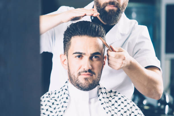 istock Barber combing male hair 687552910
