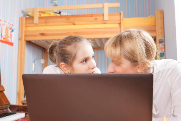 istock Mother and Daughter In Front of computer Screen. 687553908