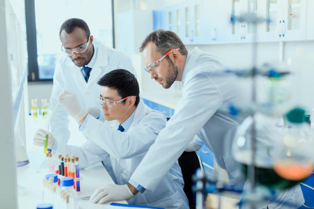 istock Professional scientists in white coats working together in chemical laboratory 687558812