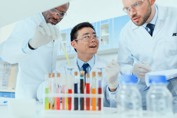 istock Professional scientists in white coats working together in chemical laboratory 687558946