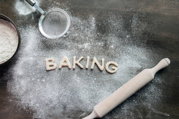 istock cookies in forms of letters with powdered sugar and rolling pin 687559204