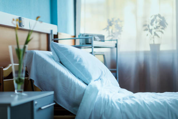 side view of empty hospital bed in clinic chamber stock photo
