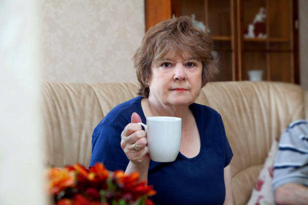 istock Retired lady sat in the living room holding a mug 687560232
