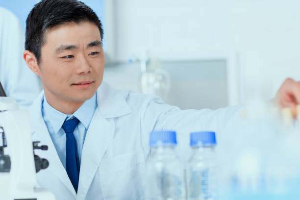 istock Asian scientist in white coat working in chemical laboratory 687560394