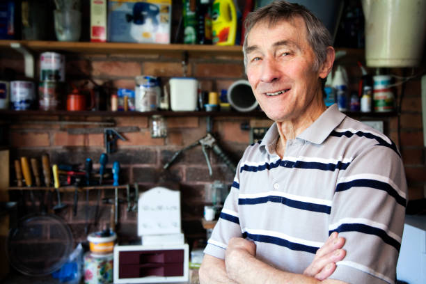 istock Retired man stood in his garage with his arms crossed 687560734