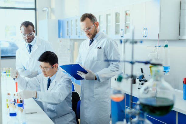 istock Professional scientists in white coats working together in chemical laboratory 687563932