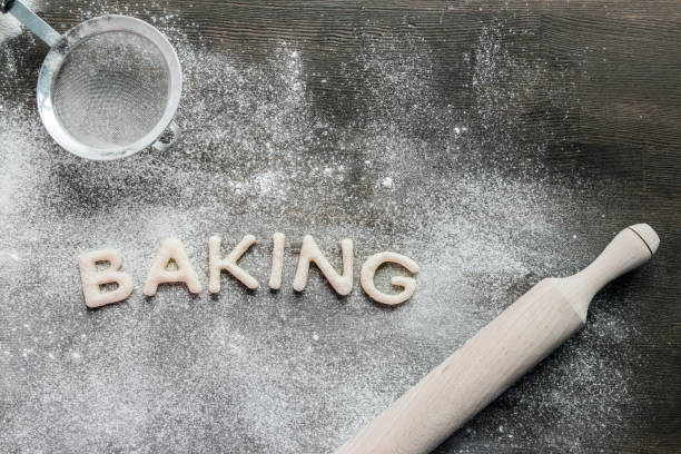 istock cookies in forms of letters with powdered sugar and rolling pin 687574520