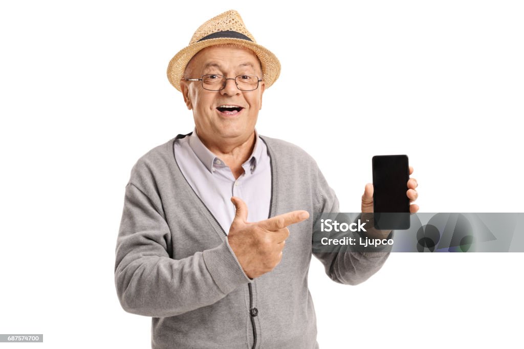 Mature man holding a phone and pointing Mature man holding a phone and pointing isolated on white background Mobile Phone Stock Photo