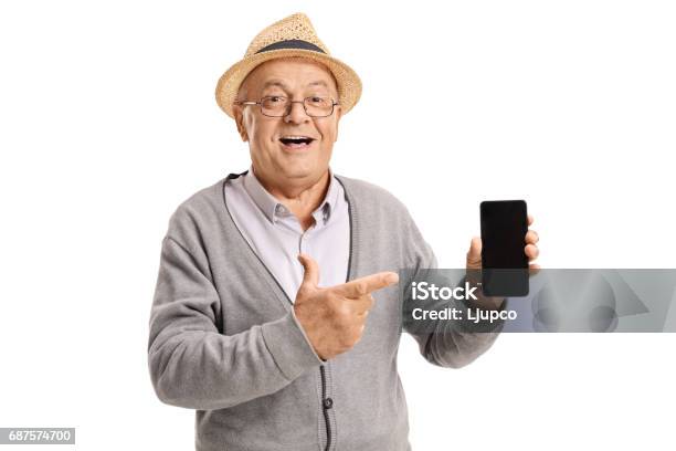Mature Man Holding A Phone And Pointing Stock Photo - Download Image Now - Mobile Phone, Senior Adult, Telephone