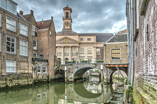 View across a canal in the old city of Dordrecht, The Netherlands towards the 14th century town hall