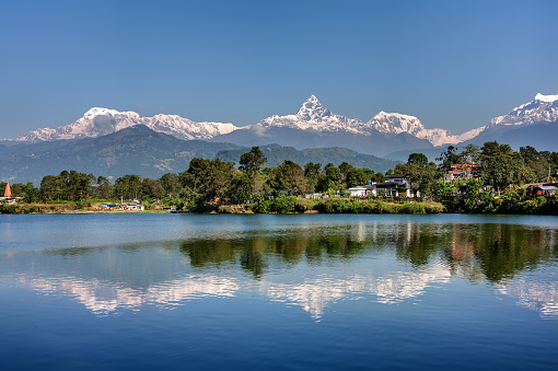 View at Annapurna mountain range and its reflection in Phewa lake in Pokhara, Nepal