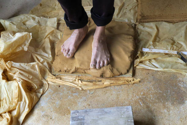 clay kneading feet, feet kneading clay at a ceramic production factory, Bat Trang, Vietnam bat trang stock pictures, royalty-free photos & images