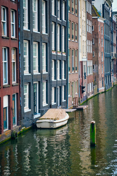 istock Amsterdam canal Damrak with houses, Netherlands 687644526