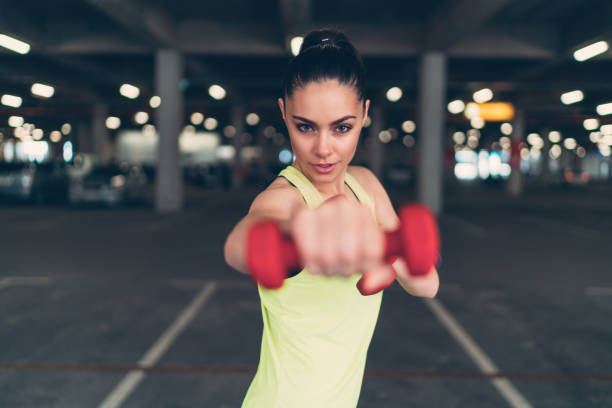 istock Sportswoman exercising with dumbbells 687649864